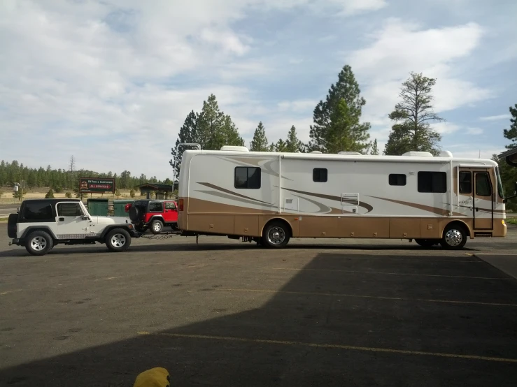 a brown and white truck pulling a trailer