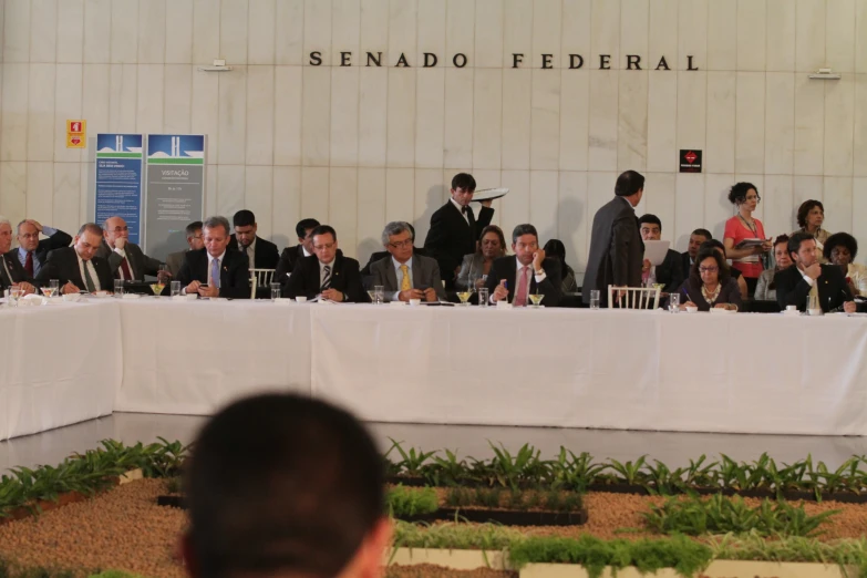 people are standing behind the table with microphones