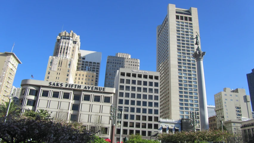 the tall buildings in the city are surrounded by greenery