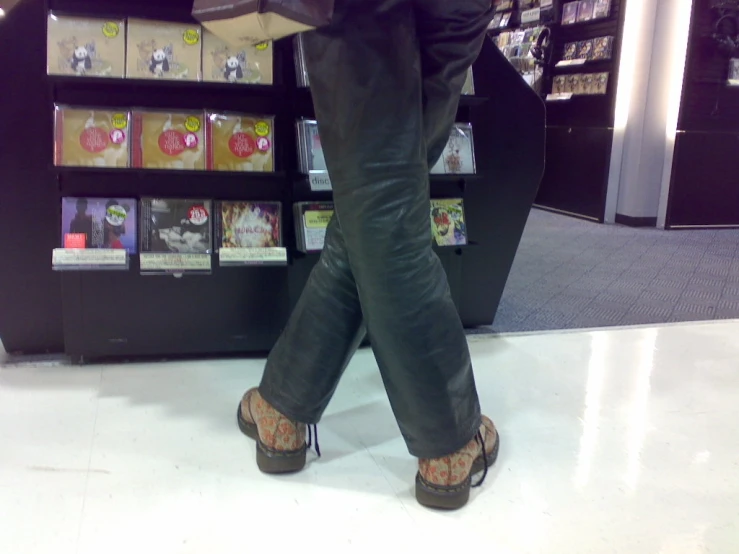 legs and shoes of people in a bookshop