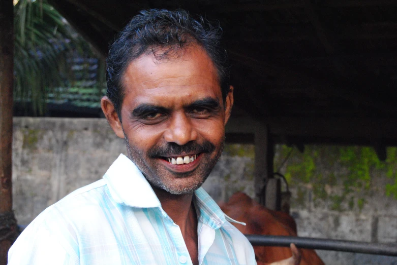 a close up of a smiling man with his horse