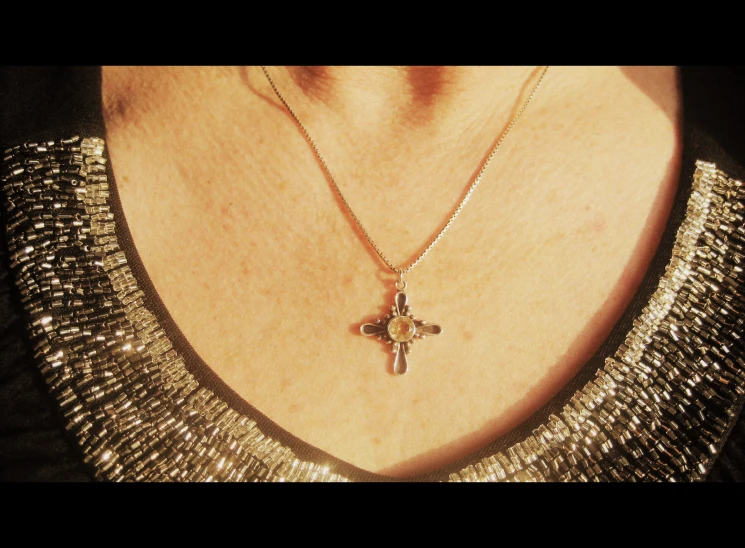 a cross necklace on a gold chain