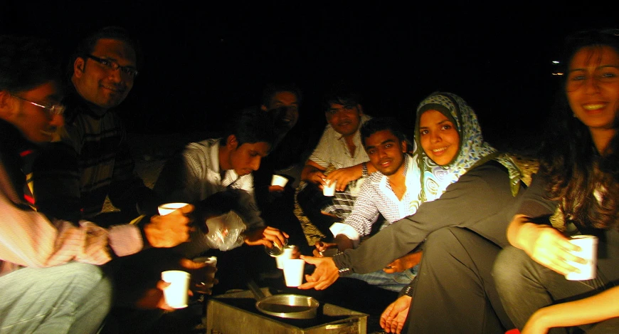 people sit around with beverages and smiles