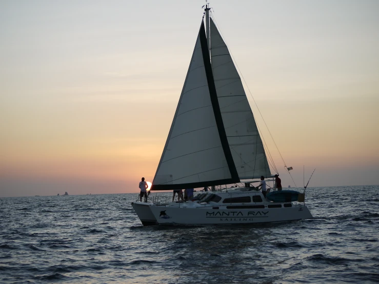 a white boat floating on top of the ocean