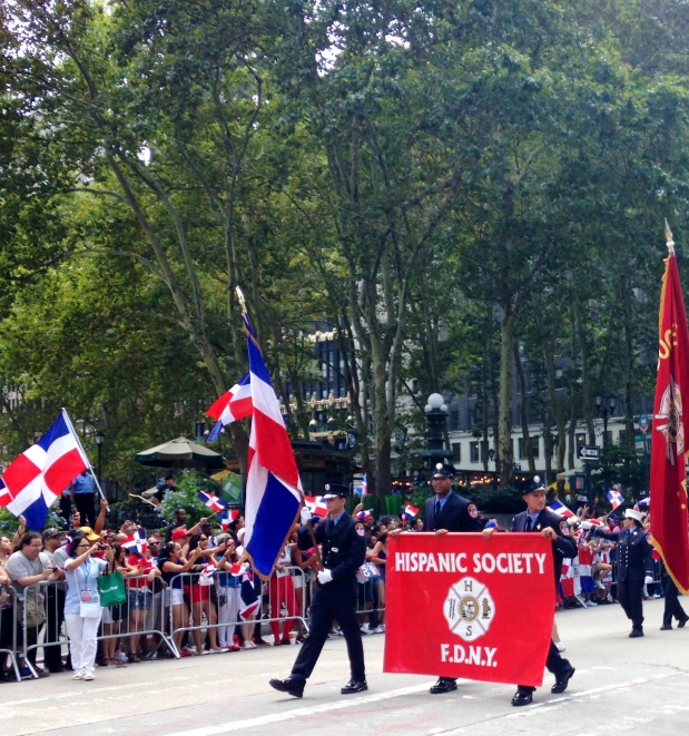 two uniformed men carrying banners on their back