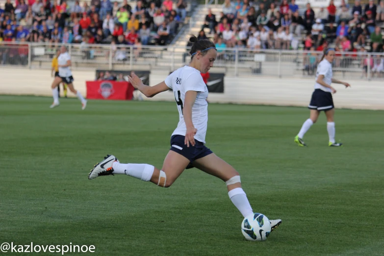 women's soccer game with people watching