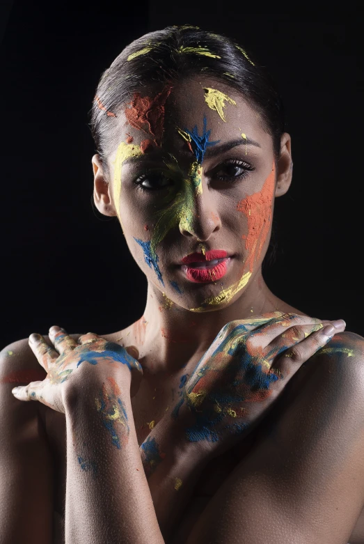 woman with colored body paint, black background