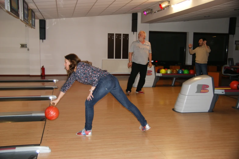a group of people playing bowling at the same time