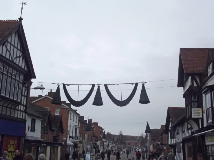 people walking down a crowded street under an overhang