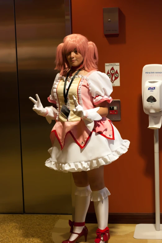 a woman dressed as a maid posing in the hallway