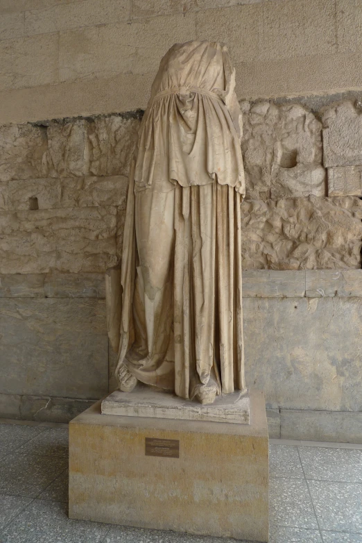 a statue of a person is in front of some walls