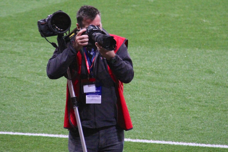 the man is posing for the camera with his camera