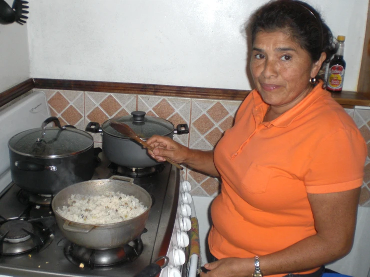 a woman is preparing food in the kitchen