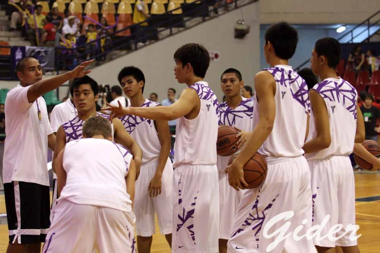 basketball players giving instructions to each other on the court