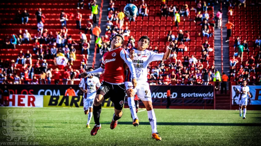 several soccer players are playing soccer on the field