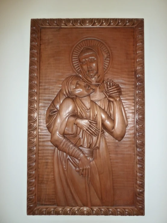 this plaque depicts the image of a person holding a child