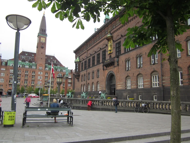 a small park near a large building with a tall tower