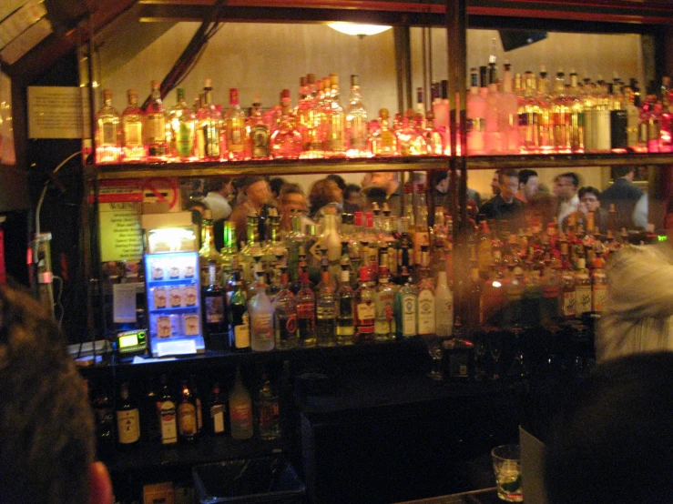 a bar full of various colorful colored alcoholic beverages