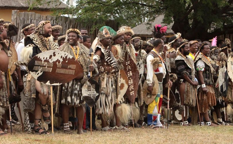 a group of men in native attire standing next to each other