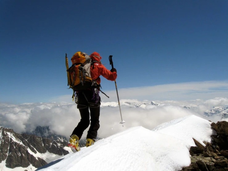 a man climbing up a snow covered mountain