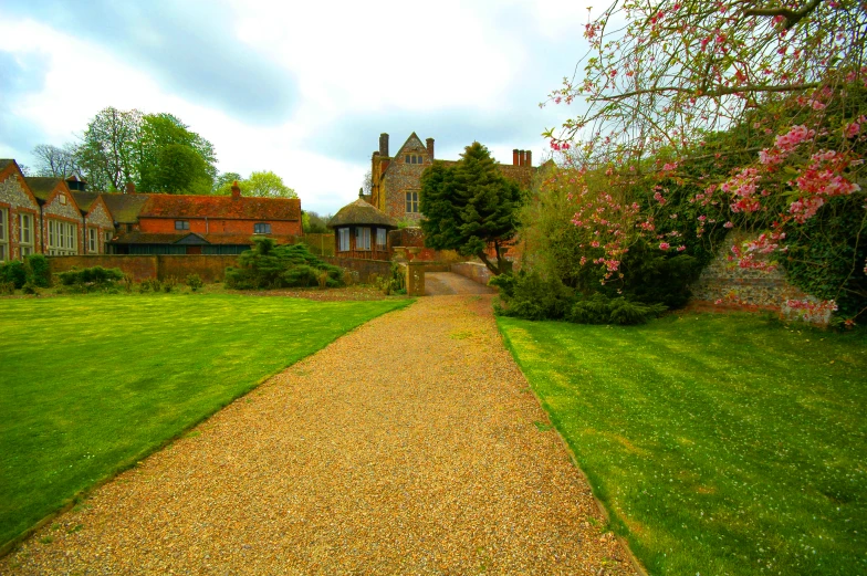 pathway next to green lawn and brick house