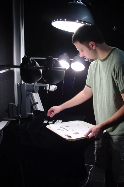 a man in front of a light in a room