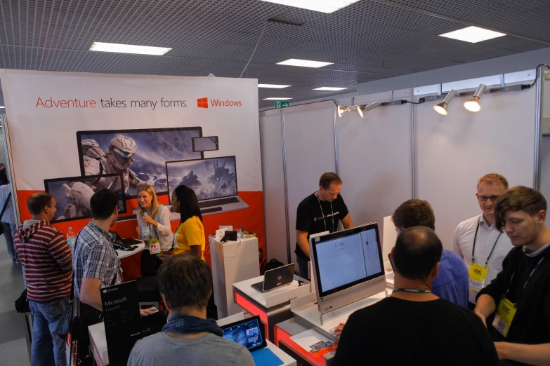 many people standing around at computers in a room