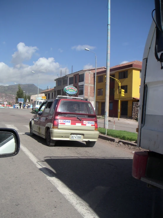 a car driving down the road with people sitting at the front