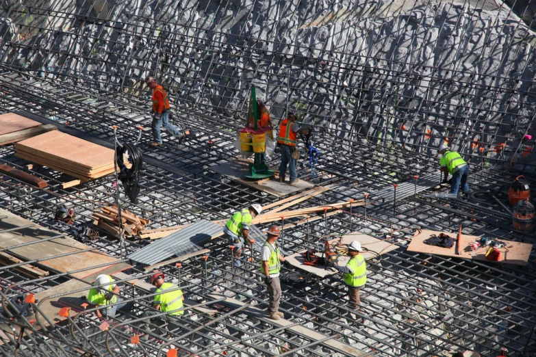 construction workers working on a structure with steel bars