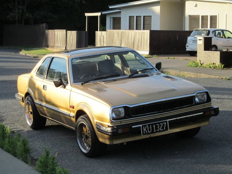 a beige car is parked in a parking lot