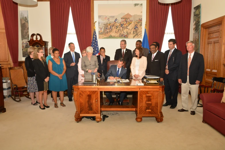 a group of people standing in front of a table