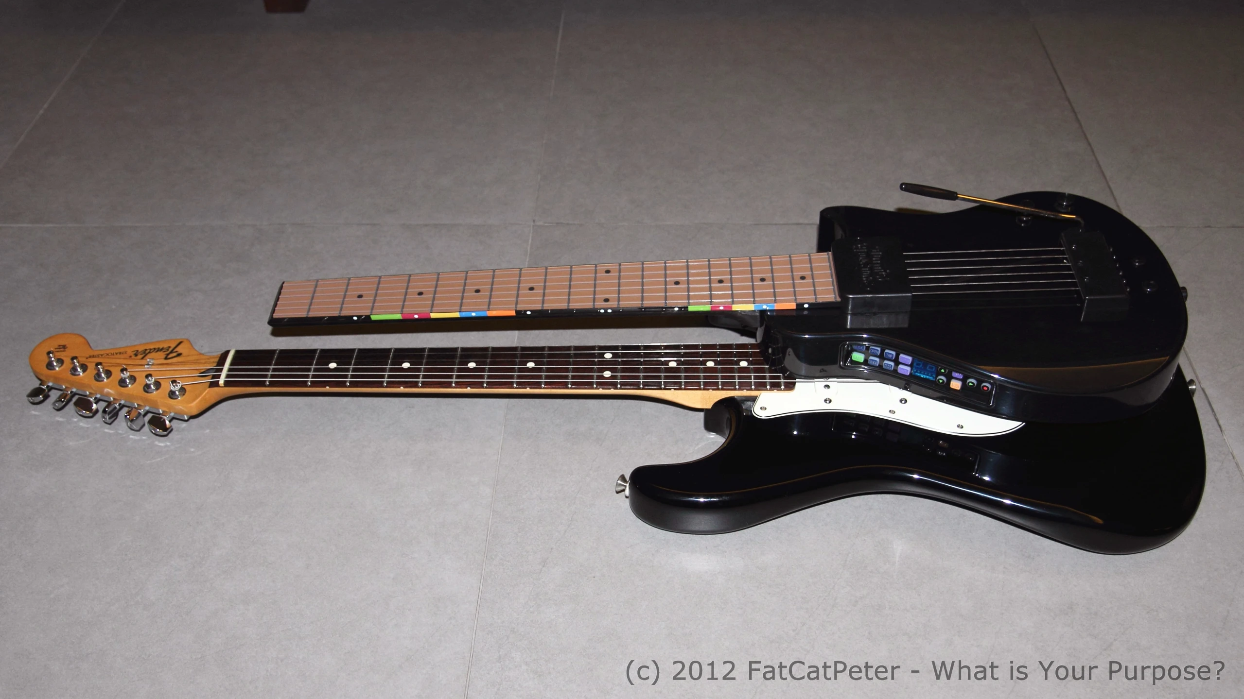 a guitar sits on the floor with it's pick up board attached to it