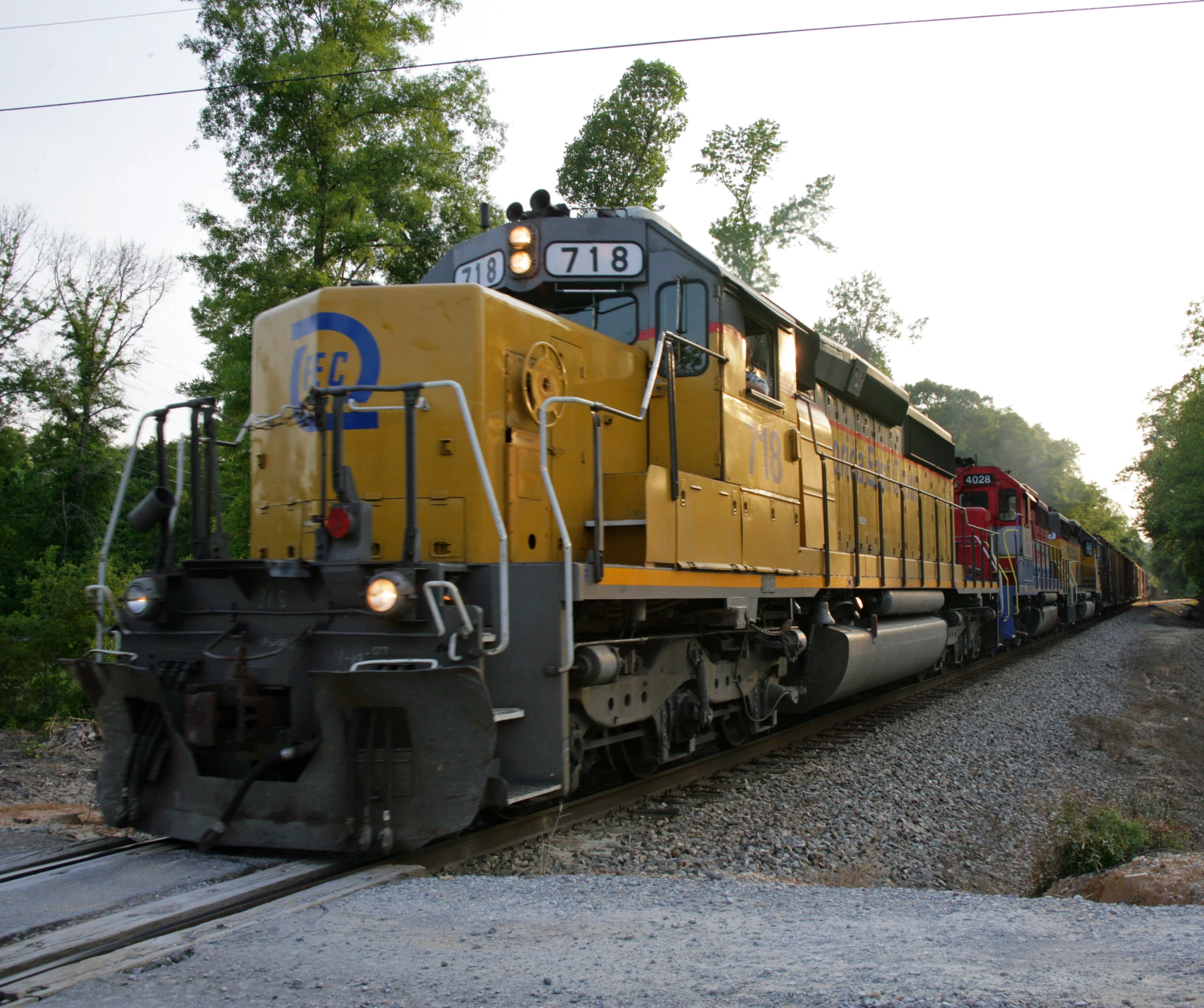 a yellow and grey train is on its tracks