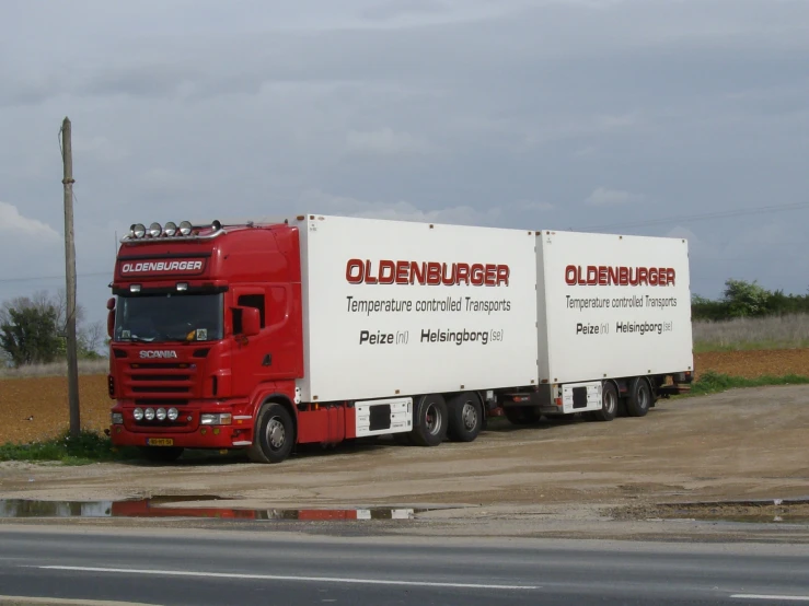 the trailer truck has two trailers on each side of it