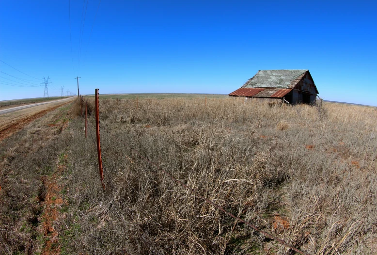 the barn in the middle of a grassy field