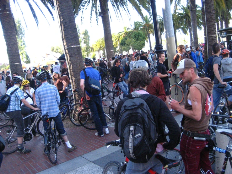 a crowd of people that are around some bikes