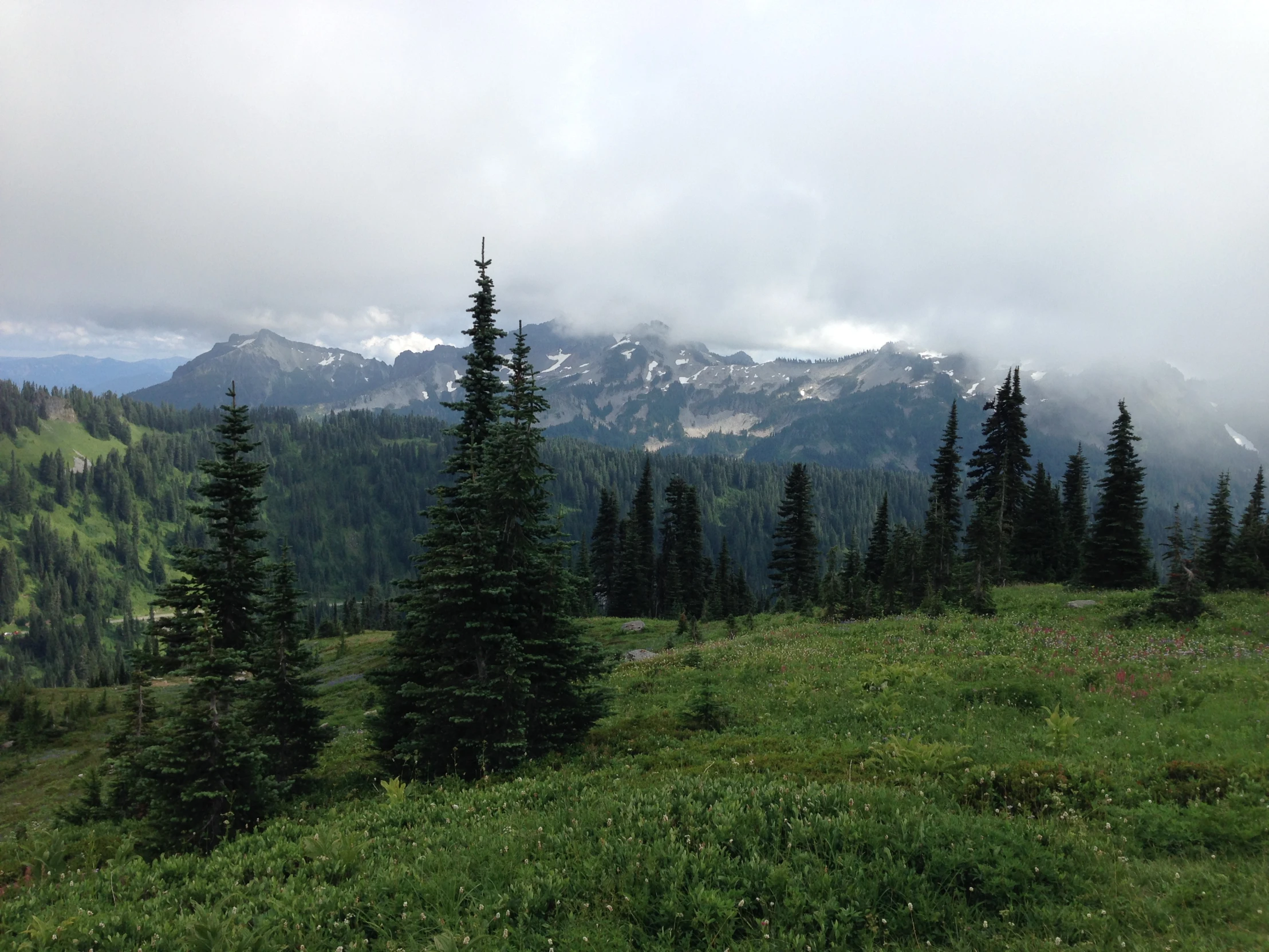 clouds roll in over the mountains on a foggy day