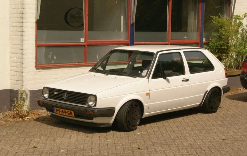 a white car parked in front of a building