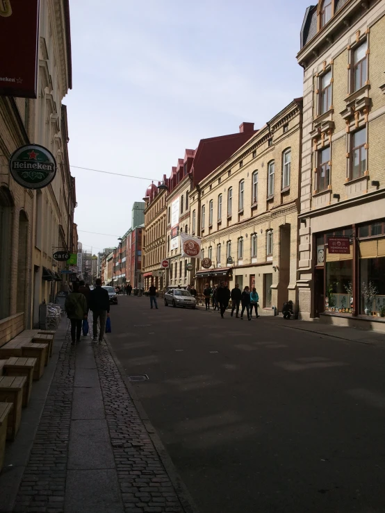 a city street lined with people, cars and buildings