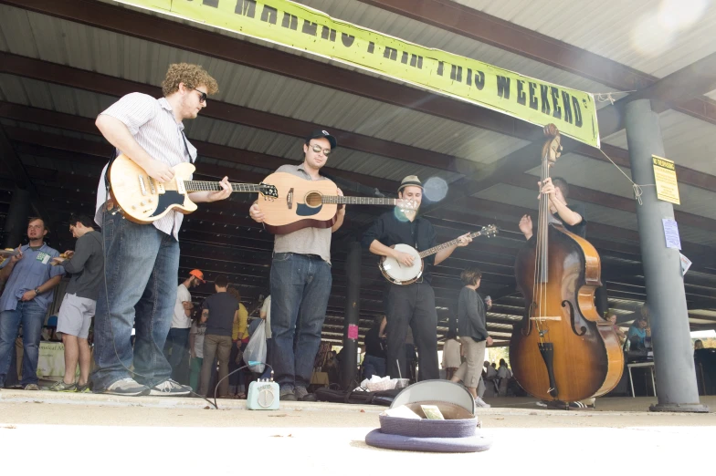 a group of guys playing music in a large building