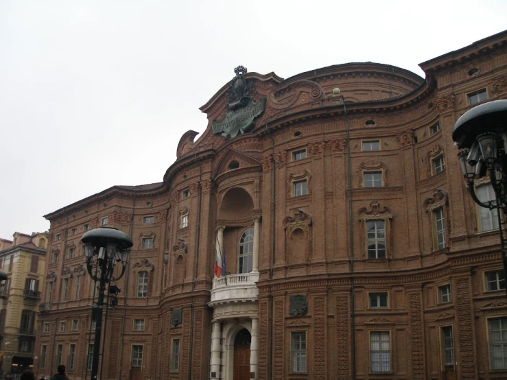 a very pretty looking brown building in front of a lot