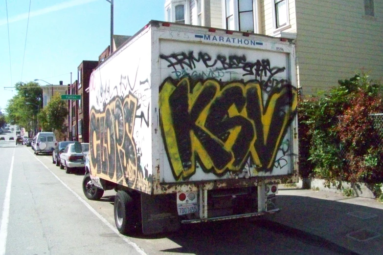 a semi truck with graffiti on the back of it