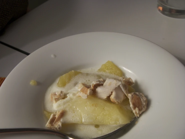 an oatmeal dish with a spoon and a drink