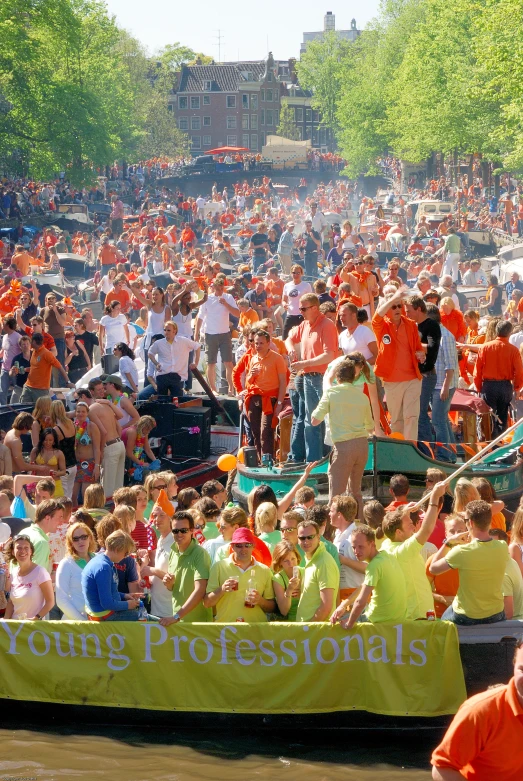 large group of people gathered at a park on boats