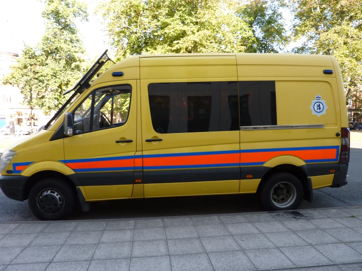 an orange bus sits parked near a curb