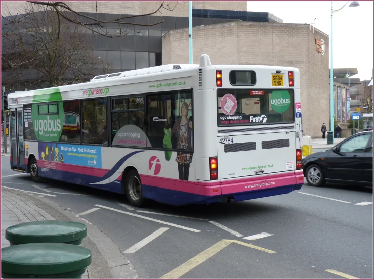 a bus with an open door traveling down the street