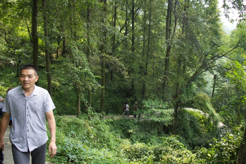 two young men standing in front of a forest