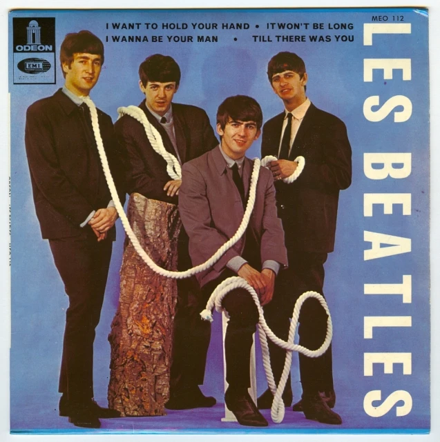 the beatless are posing on a blue background with an advertit in front