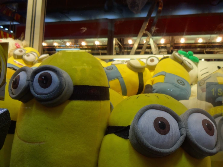 several stuffed minionsettes are lined up and ready to be put into a store window