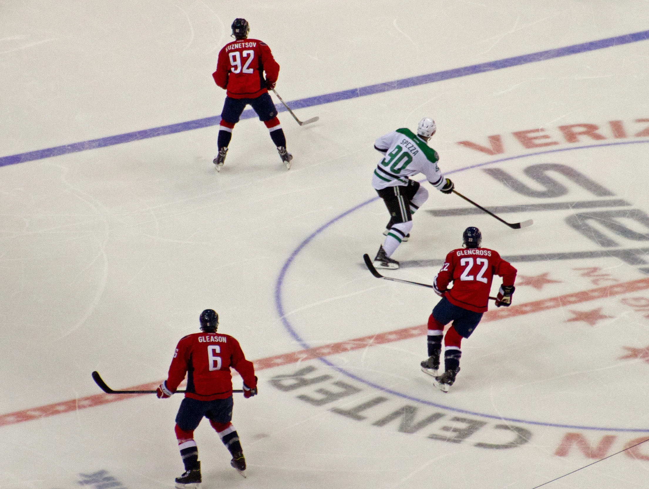 several people playing a game of hockey on an ice rink